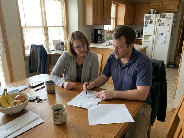 Homeowner reviewing a radon test report with hourly graph