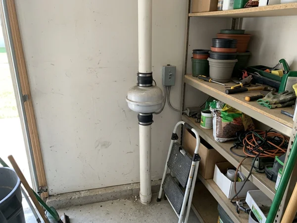 Inline radon fan mounted in an attached garage
